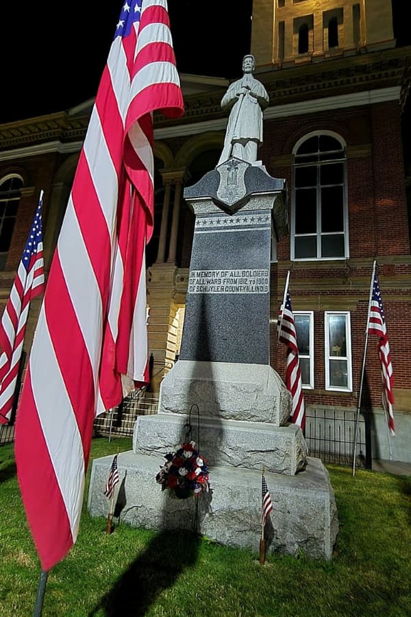 Schyler County Courthouse with flag and statue in front