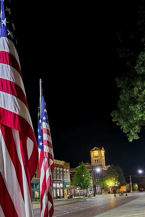 Schyler County Courthouse with flags at night