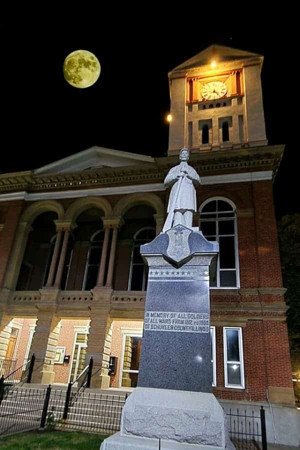Schyler County Courthouse with statue with the moon in the background